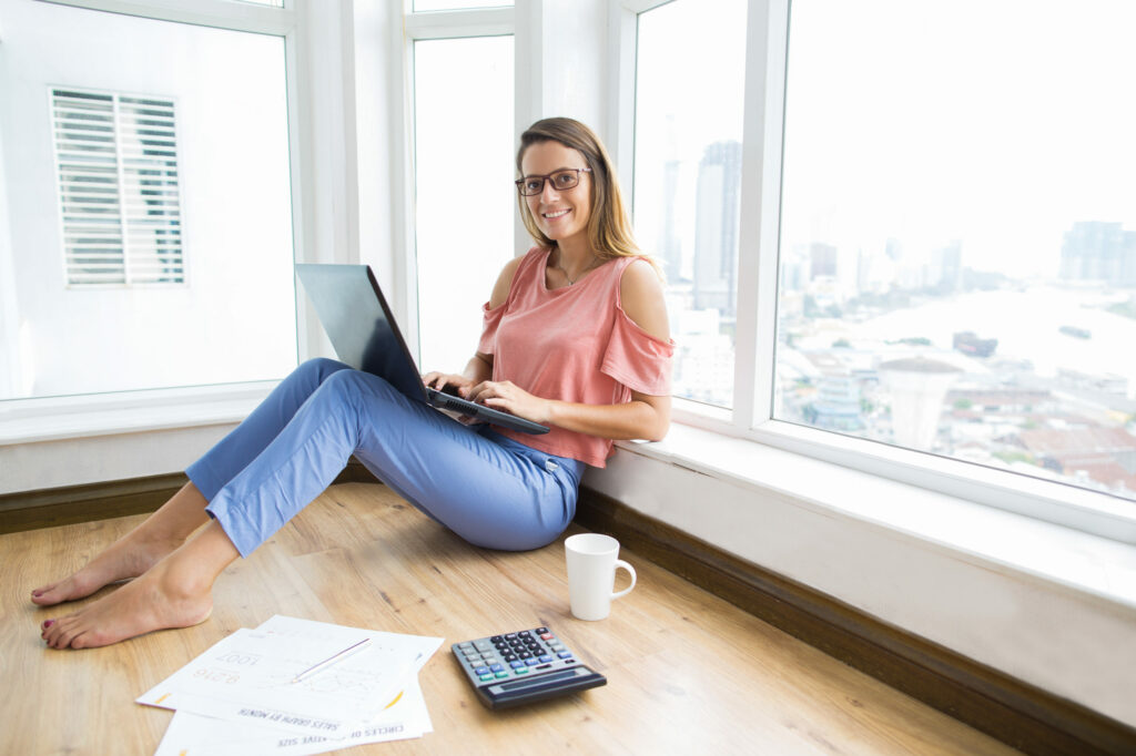 Smart female financier working on laptop